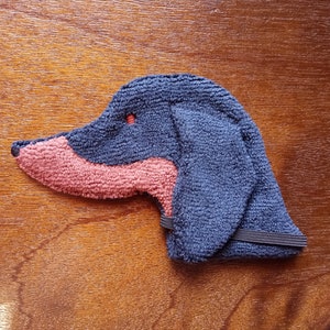Soft, microfiber terry cloth towels cut, sewn, and made in the shape of the head of a Dachshund. Little larger than palm sized. Texture of the Smudge Dog is perfect for cleaning cell phone screens, musical instruments, glasses, etc.