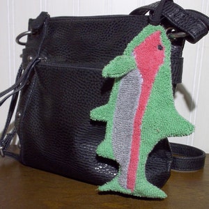 Smudge Fish have a 1/4 inch braided elastic loop that can be used to secure to purse, handbag, back pack, etc. The elastic helps it from getting lost in the bottom of a bag.