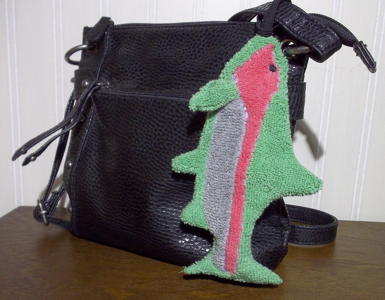 Smudge Fish have a 1/4 inch braided elastic loop that can be used to secure to purse, handbag, back pack, etc. The elastic helps it from getting lost in the bottom of a bag.