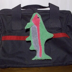 Smudge Fish have a 1/4 inch braided elastic loop that can be used to secure to tool bag, handbag, back pack, etc. The elastic helps it from getting lost in the bottom of a bag.