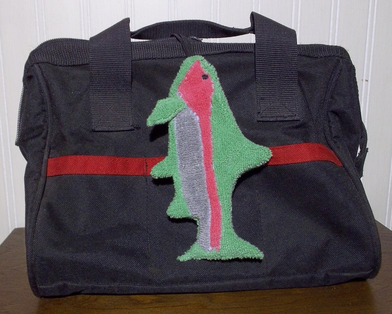 Smudge Fish have a 1/4 inch braided elastic loop that can be used to secure to tool bag, handbag, back pack, etc. The elastic helps it from getting lost in the bottom of a bag.