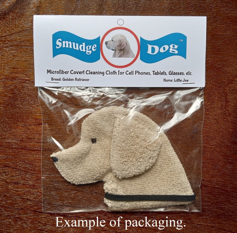 This is a photo that shows an example of the packaging used for Smudge Dogs. Each dog will come in a sandwich sized zip top bag with a card stock hang tag on it. The tag has the Smudge Dog logo as well as the breed and dog name. Directions on back.