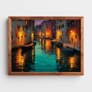 May include: A framed painting depicts a canal scene at dusk. Buildings with warm, inviting lights line the water's edge. Several boats are docked along the canal, and the water reflects the lights and colors of the buildings. The painting is in a wooden frame.