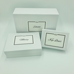 Three different sized personalised white magnetic boxes against a white background. Your order will be packaged in a personalised magnetic box. By Bespoke Munchkin.