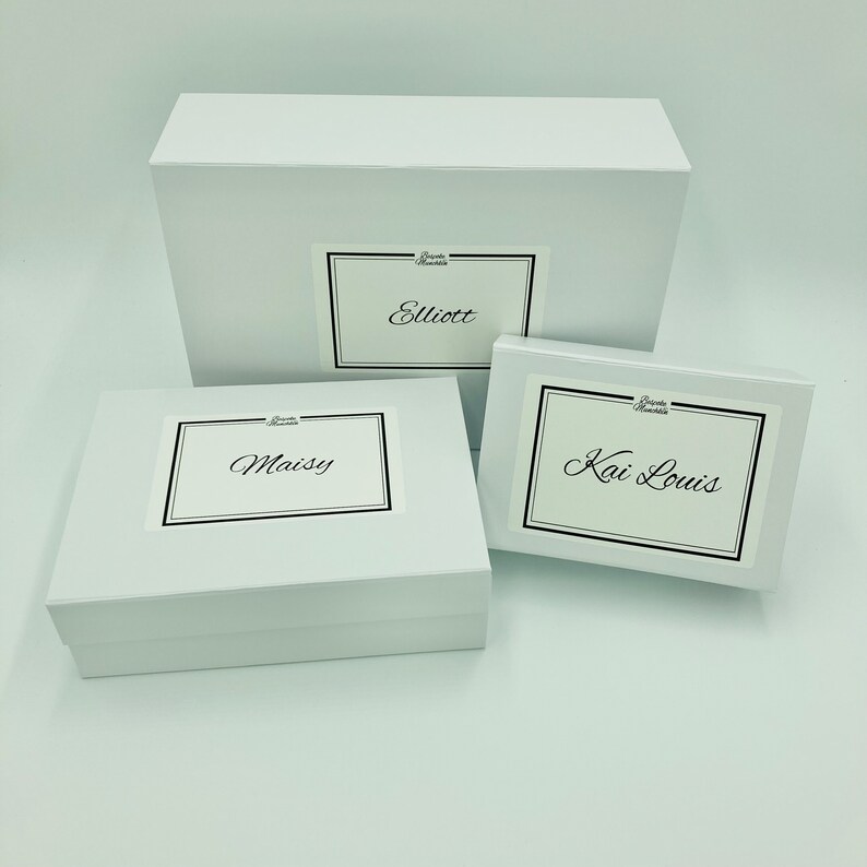 Three different sized personalised white magnetic boxes against a white background. Your order will be packaged in a personalised magnetic box. By Bespoke Munchkin.