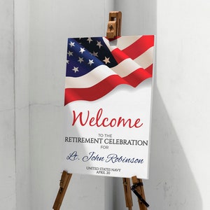 May include: Welcome to the Retirement Celebration for Lt. John Robinson, United States Navy, April 20. A white sign with red, white, and blue text is displayed on a wooden easel with an American flag in the background.