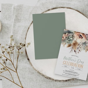 May include: A white invitation card with a watercolour floral design in shades of brown, green, and pink. The text on the card reads "Join us for a Mother's Day Celebration" with the date "May 15, 11 AM" and the host "The Robinson Family".