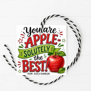 May include: A square gift tag with black and white striped string featuring the text "YOU ARE APPLE-SOLUTELY THE BEST!" in red and green lettering. A bright red apple illustration with green leaves is included, along with the text "FROM: JESSICA ROBINSON".