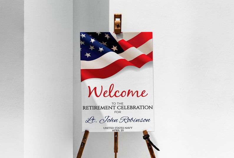 May include: Welcome to the Retirement Celebration for Lt. John Robinson, United States Navy, April 20. A white sign with red, white, and blue text and a waving American flag in the top left corner.