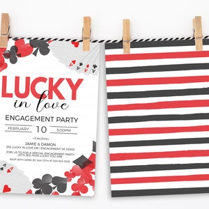 K&ouml;nnte beinhalten: Zwei Karten h&auml;ngen an W&auml;scheklammern vor wei&szlig;em Hintergrund. Eine Karte verk&uuml;ndet "Lucky in Love" und eine Verlobungsfeier am 10. Februar. Die andere Karte hat rote, schwarze und wei&szlig;e horizontale Streifen.