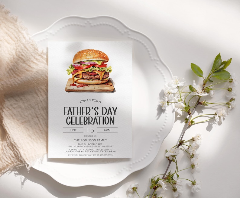 May include: A white card with a Father's Day celebration invitation. The card features a watercolor illustration of a hamburger with lettuce, tomato, onion, and cheese. The text on the card reads "Join us for a Father's Day Celebration, June 15, 6PM, Hosted by The Robinson Family, The Burger Cafe, 555 Celebration Dr, Spring VA 55555, Join us for a cookout to celebrate our favorite Father's! Bring a side & YOB! RSVP with Jamie by May 1st at 555-555-5855."