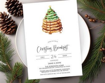 May include: A white invitation card with a watercolor illustration of a Christmas tree made of pancakes. The text on the card reads "Join us for a Christmas Breakfast, Dec 24, 9AM, Hosted by: Jamie & John, The Robinson Home, 555 Celebration Dr | Christmas VA 55555, Please join us to celebrate Christmas Breakfast & drinks will be served, RSVP with Jamie by Dec 10th at 555-555-5555".