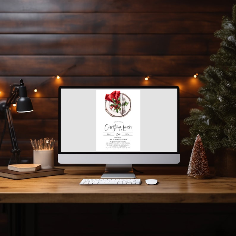 May include: A computer screen displaying a Christmas lunch invitation with a watercolour illustration of a plate with a red napkin, silverware, and holly berries. The invitation includes the date, time, and location of the event.