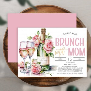May include: Invitation to a brunch with Mom to celebrate Mother's Day. The invitation features a watercolor illustration of champagne flutes, a bottle of champagne, and pink roses. The text reads "Join us for Brunch with Mom" and includes the date, time, and location of the event.