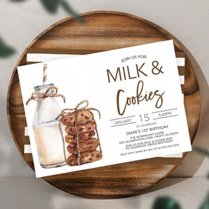 May include: A white invitation card with brown text that reads "Join us for Milk & Cookies" and details for a first birthday party. The card features a watercolor illustration of a glass bottle of milk and a stack of chocolate chip cookies.