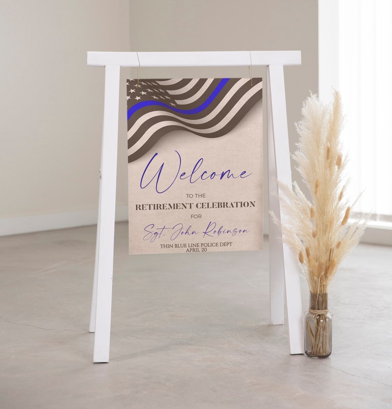 May include: Welcome to the retirement celebration for Sgt. John Robinson, Thin Blue Line Police Dept., April 20. The sign features a blue line American flag with a brown background.