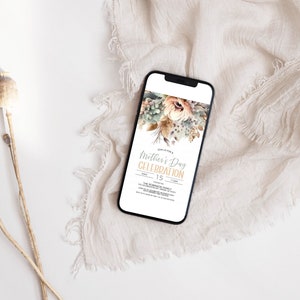 May include: A smartphone displaying a digital invitation for a Mother's Day celebration. The invitation features a watercolour floral design in shades of beige, brown, and green. The text reads "Mother's Day Celebration" with the date "May 15".