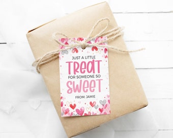 May include: A white gift tag with pink hearts and the text "Just a little treat for someone so sweet. From: Jamie".