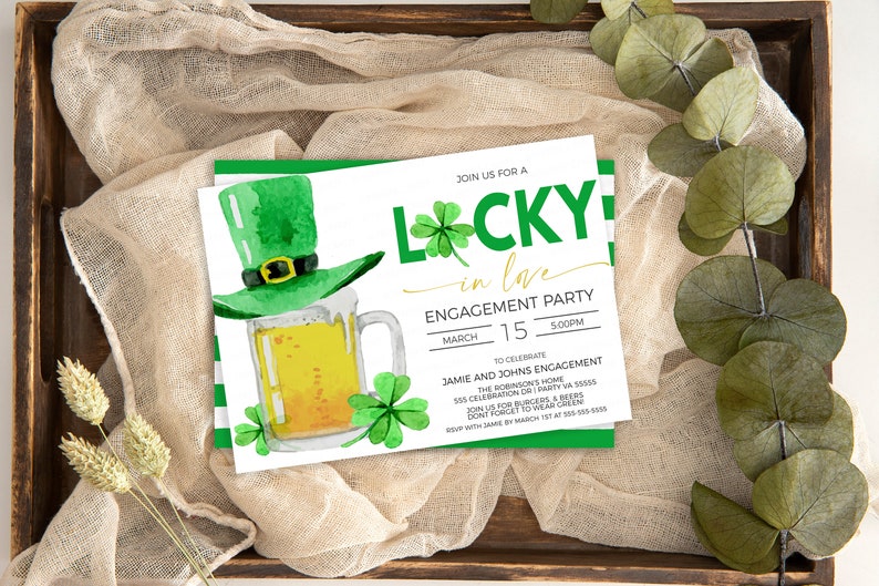 May include: An engagement party invitation with a St. Patrick's Day theme. The invitation features a green leprechaun hat, a mug of beer, and shamrocks. The text reads "Lucky in Love" and includes event details.