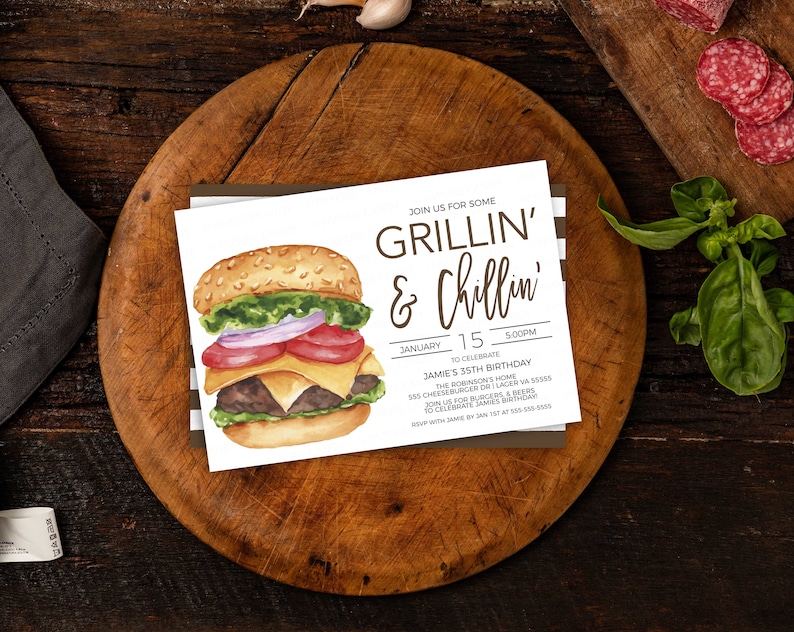 May include: A white invitation card with brown text that reads "Join us for some Grillin' & Chillin'" and details for a birthday party. The card features a watercolour illustration of a hamburger with lettuce, tomato, onion, cheese, and a beef patty.