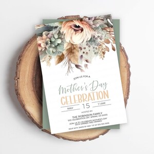 May include: A white invitation card with a floral design in shades of brown, green, and peach. The text reads "Join us for a Mother's Day Celebration, May 15, 11 AM, Hosted by The Robinson Family, 135 Celebration Dr, Spring VA 35353, Join us to celebrate Mother's Day with dinner and drinks."