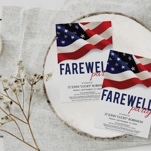 May include: Two white cards with red, white, and blue American flag designs. The cards are on a white wooden surface. The text on the cards reads "Farewell party" in honor of "LT John "Lucky" Robins" and "LT John "Lucky" Robinson".