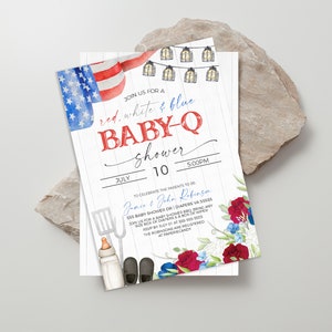 May include: Red, white, and blue baby shower invitation with a watercolor American flag, string lights, and a spatula, baby bottle, and baby shoes. The text reads "Join us for a red, white & blue baby-q shower" and "July 10, 5:00pm".