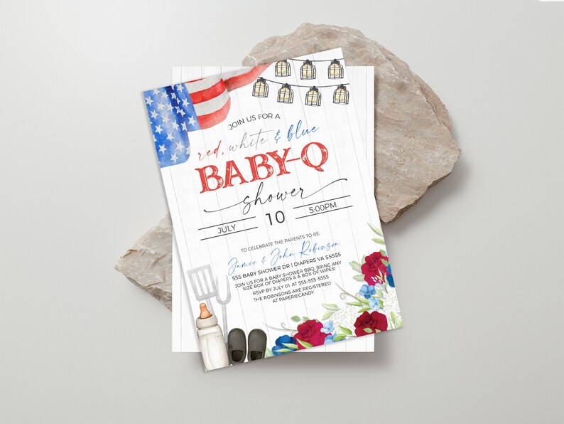 May include: Red, white, and blue baby shower invitation with a watercolor American flag, string lights, and a spatula, baby bottle, and baby shoes. The text reads "Join us for a red, white & blue baby-q shower" and "July 10, 5:00pm".