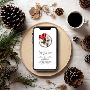 May include: A digital invitation on a smartphone screen for a Christmas lunch on 24th December at 12:00 PM. The invitation is hosted by the Robinson family at their home. The invitation features a watercolour illustration of a festive table setting with a red napkin, silver cutlery, and a sprig of holly.