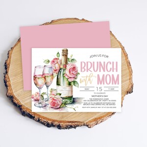 May include: A pink and white invitation card with a watercolor illustration of a champagne bottle, two glasses of champagne, and pink roses. The text on the card reads "Join us for Brunch with Mom" and includes the date and time of the event.