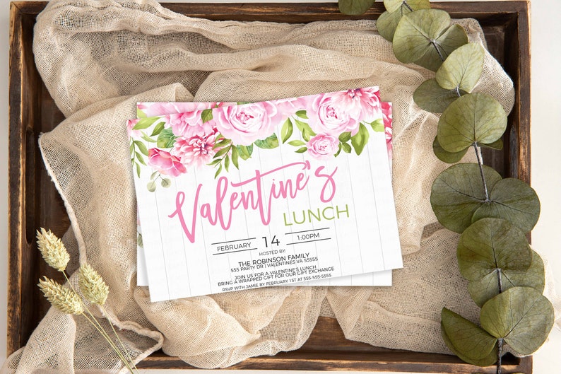May include: A white invitation with pink floral border and text that reads "Valentine's Lunch" with the date "February 14" and time "1:00PM". The invitation is hosted by "The Robinson Family" and includes the address "555 Party Dr.  Valentine, VA 55555".
