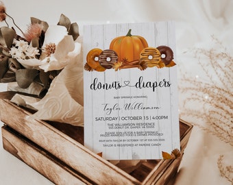 May include: A baby sprinkle invitation with a white woodgrain background. The invitation features a pumpkin, donuts, and fall leaves. The text reads "donuts diapers" and "Baby Sprinkle Honoring Taylor Williamson". The date and time of the event are listed as "Saturday, October 15, 4:00 PM". The address is "The Williamson Residence, 555 Donut Dr. Diaper, VA 55555". The invitation also includes the RSVP information and the registry information.