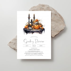 May include: A black and white invitation for a Spooky Dinner on October 30th at 6 PM. The invitation features a watercolor illustration of a table with pumpkins, candles, and fall foliage. The text "JOIN US FOR A Spooky Dinner" is written in a decorative font.