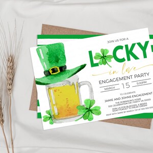 May include: Engagement party invitation with a watercolor illustration of a green leprechaun hat, a mug of beer, and shamrocks. The invitation reads "Lucky in Love" and includes event details.