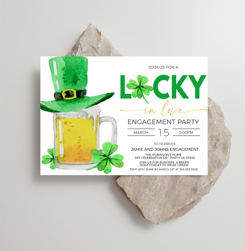 May include: An engagement party invitation with a watercolor design. The invitation features a green leprechaun hat atop a beer mug, shamrocks, and the words "Lucky in Love." The date and time of the party are also included.