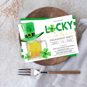 May include: St. Patrick's Day engagement party invitation with a green leprechaun hat, beer mug, and shamrocks. The invitation reads "Lucky in Love" and includes the date, time, and event details. The invitation is on a white background with green accents.