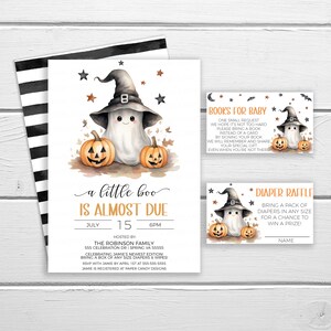 May include: A Halloween-themed baby shower invitation with a cute ghost wearing a witch hat and holding pumpkins. The invitation says "a little boo is almost due" and includes the date, time, and location of the event. It also includes information about bringing diapers and a book for the baby.