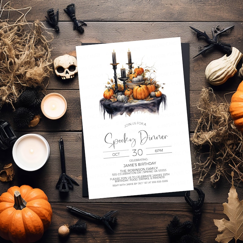 May include: A white invitation card with a spooky dinner theme. The card features a watercolor illustration of a black table with candles, pumpkins, and fall leaves. The text on the card reads "Join us for a Spooky Dinner, Oct 30, 6pm, Celebrating Jamie's Birthday, The Robinson Family, 555 Celebration Dr Spring VA 55555, Please join us to celebrate Jamie's 35th Birthday, Food, Drinks, & Friends, RSVP with Jamie by Oct 1st at 555-555-5555."
