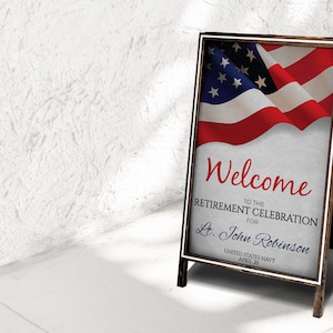 May include: A wooden A-frame sign with a white border and a folded American flag in the background. The sign reads "Welcome to the Retirement Celebration for Lt. John Robinson United States Navy April 30".