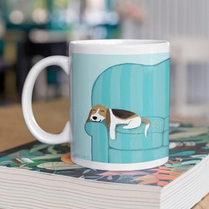 Cute Beagle Coffee Mug. Drawing of a Beagle sleeping on a teal blue striped sofa