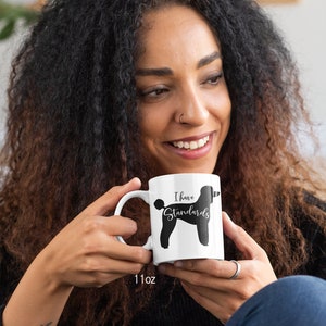 Woman Holding 11oz Mug with Black Standard Poodle Silhouette. I Have Standards