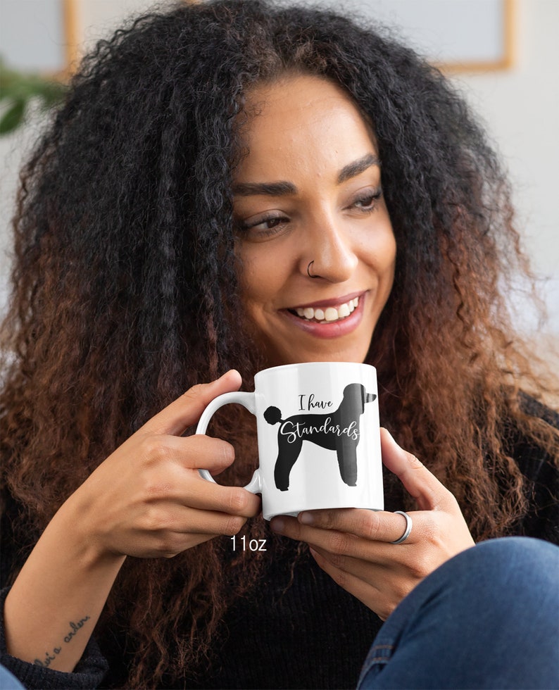 Woman Holding 11oz Mug with Black Standard Poodle Silhouette. I Have Standards