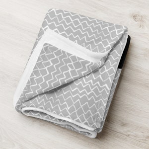 folded blanket with grey and white zigzag pattern