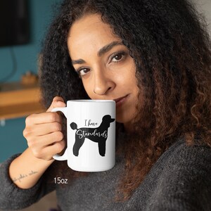 Woman Holding 15oz Mug with Black Standard Poodle Silhouette. I Have Standards
