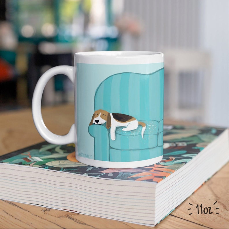 Cute Beagle Coffee Mug. Drawing of a Beagle sleeping on a teal blue striped sofa