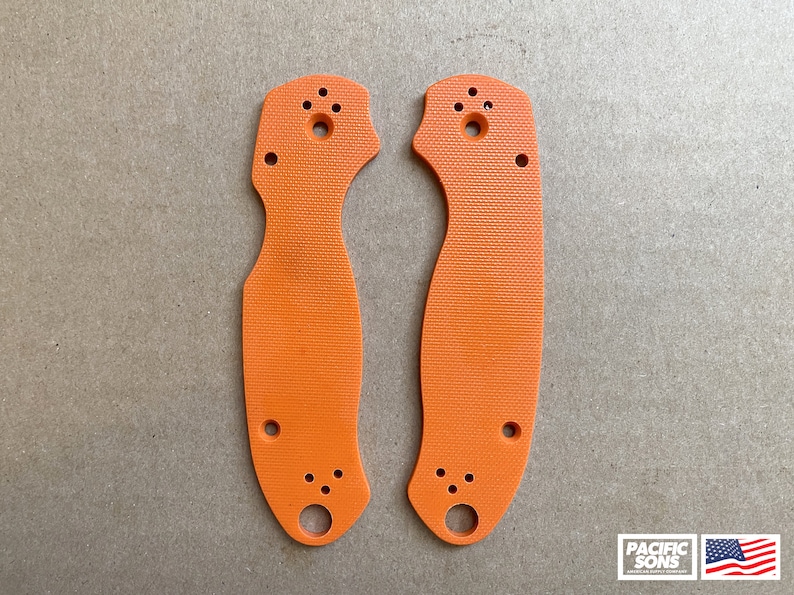 May include: Two orange plastic knife scales with holes for mounting hardware.