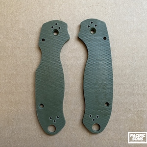 May include: A pair of green knife scales with a textured surface and multiple holes. The scales are made of G10 material.