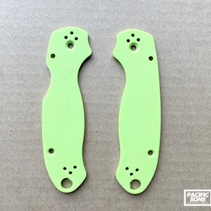 May include: Two lime green knife scales with multiple holes for mounting hardware.