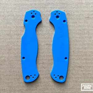 May include: A pair of blue plastic knife scales. The scales have a textured surface and are designed to fit a specific knife model.