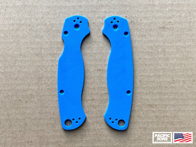 May include: A pair of blue plastic knife scales. The scales have a textured surface and are designed to fit a specific knife model.